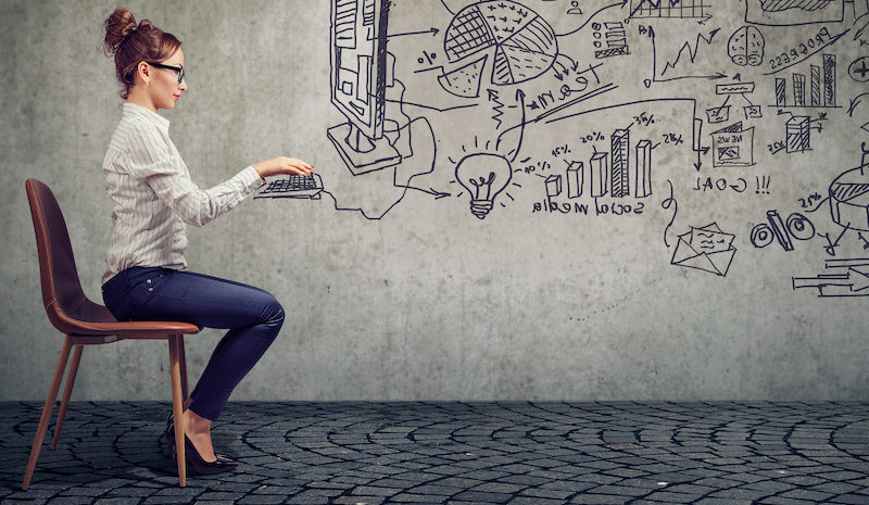 businesswoman working in an office brainstorming business plan