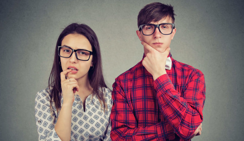 Doubtful couple looking at camera