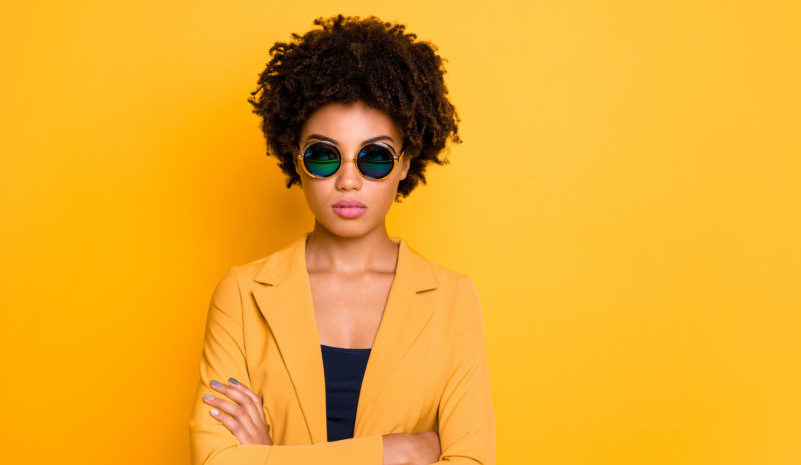 Close-up portrait of nice fashionable attractive luxury content calm serious wavy-haired girl folded arms spring season trend isolated over bright vivid shine vibrant yellow color background